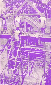 Lubwa Church. (With foundations of new hospital in the foreground.) In course of erection. Rev Dr Brown is seen putting in key bricks of arch. His native assistants are also seen at work, Everything - bricks, tiles, couples, boards, windows, doors, etc. - made on the spot by native boys, under the supervision of Rev Dr Brown. Only glass, nails, locks etc. are imported